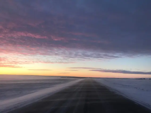 Winter prairie road at sunset